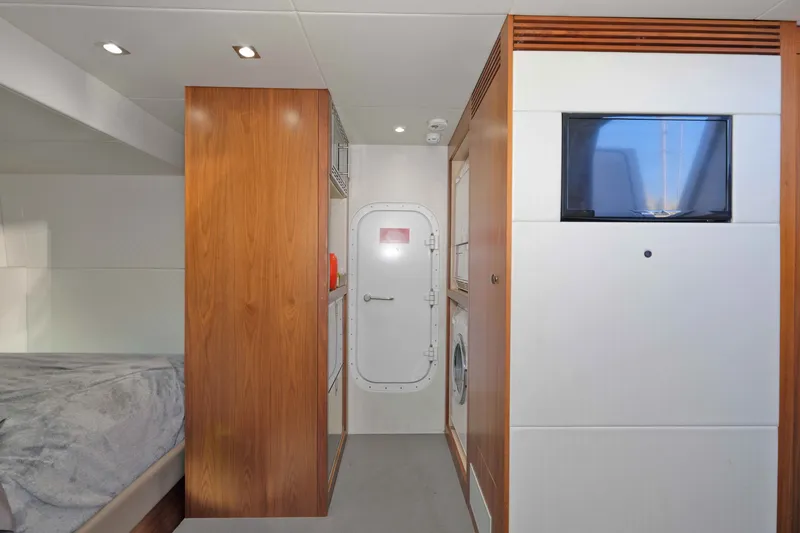 Slide: The Image of Interior of 2018 Sunseeker 76 Yacht featuring modern wood paneling and built-in appliances. - 81