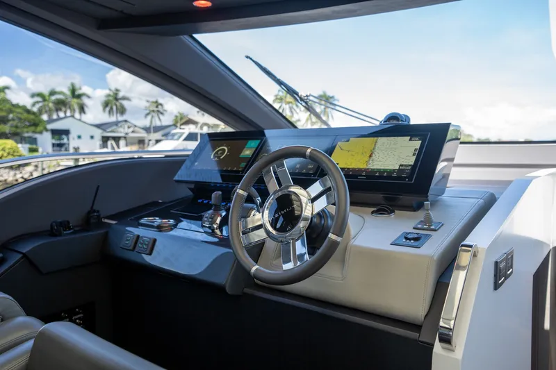 Slide: The Image of 2023 Azimut S8 yacht helm with modern navigation displays and sleek steering wheel. - 43