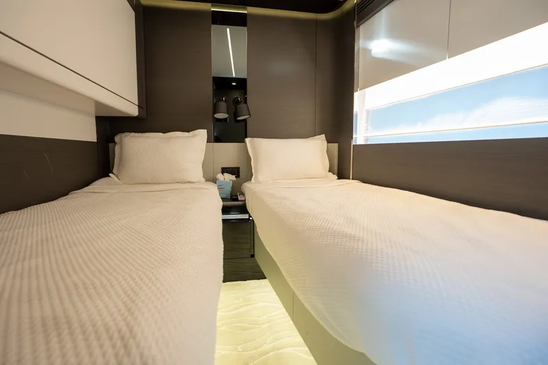 Slide: The Image of Luxurious twin cabin interior of 2023 Azimut S8 yacht, featuring modern design and cozy bedding. - 24