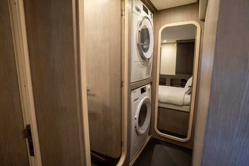Slide: The Image of Laundry area with washer, dryer, and mirror in 2023 Azimut S8 yacht. - 35