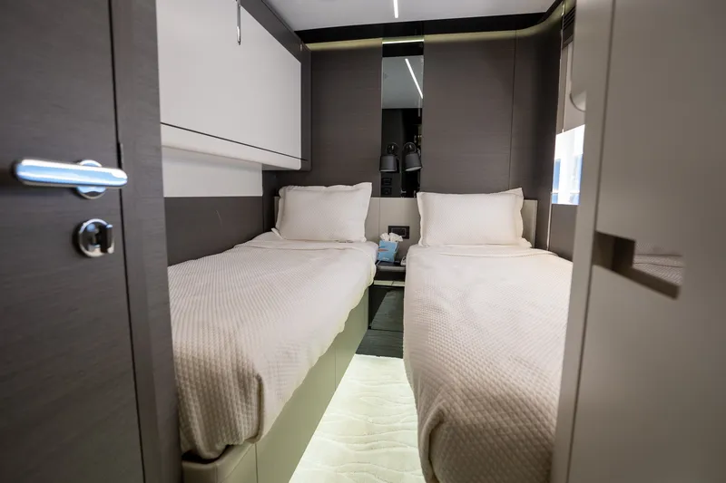 Slide: The Image of Luxurious twin cabin interior of 2023 Azimut S8 yacht, featuring modern design and cozy bedding. - 26