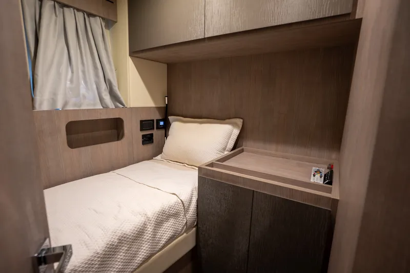 Slide: The Image of 2023 Azimut S8 yacht cabin with cozy bed and modern wood finish. - 36