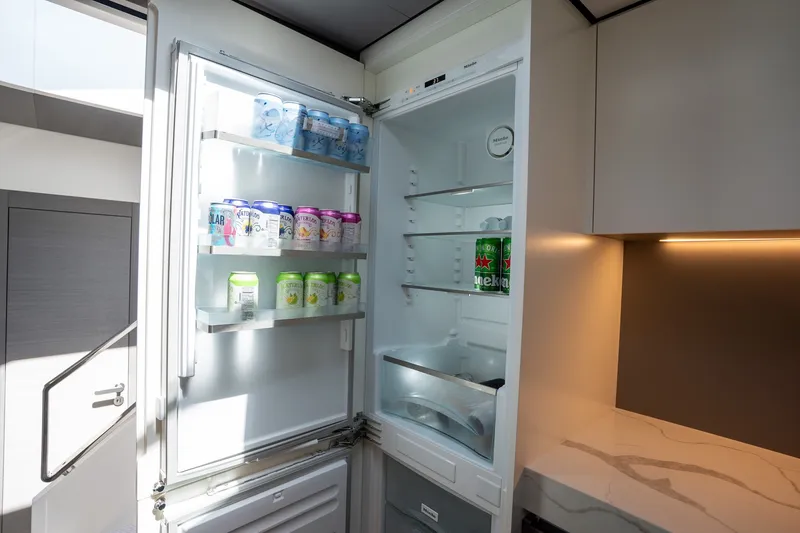 Slide: The Image of Modern kitchen fridge in 2023 Azimut S8 yacht, stocked with beverages. - 38