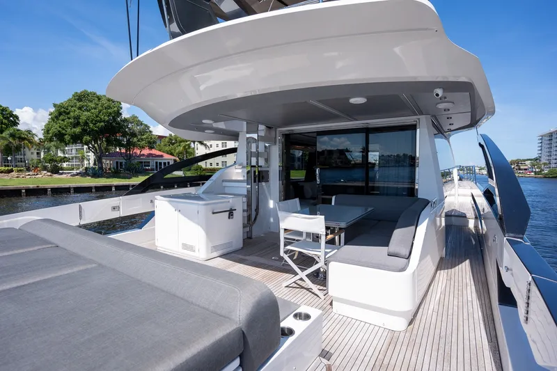 Slide: The Image of Luxurious 2023 Azimut S8 yacht deck with seating area and scenic waterfront view. - 52