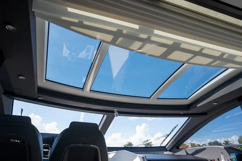 Slide: The Image of Interior view of 2023 Azimut S8 yacht with panoramic sunroof and clear blue sky. - 70