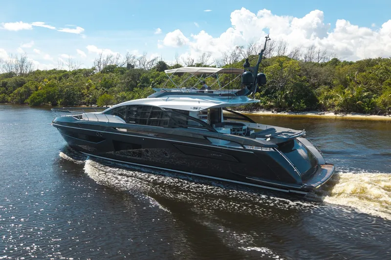 Slide: The Image of 2023 Azimut S8 yacht cruising on a scenic river under a clear blue sky. - 15