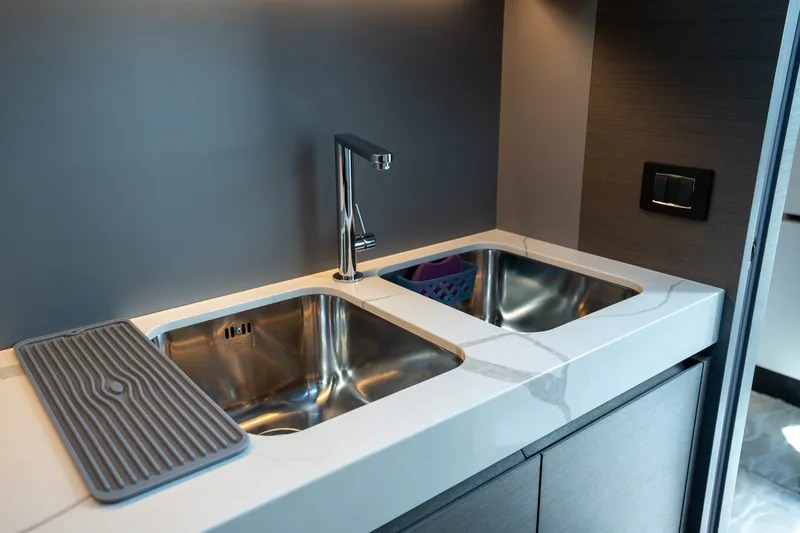 Slide: The Image of Modern kitchen sink in 2023 Azimut S8 yacht, featuring dual basins and sleek faucet design. - 42