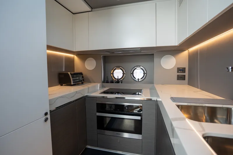 Slide: The Image of Modern kitchen interior on 2023 Azimut S8 yacht, featuring sleek cabinetry and appliances. - 40