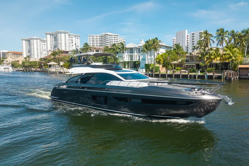 Slide: The Image of Luxury 2023 Azimut S8 yacht cruising near waterfront homes and palm trees. - 14