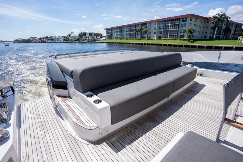 Slide: The Image of Luxurious 2023 Azimut S8 yacht deck with sleek seating, cruising on a sunny waterfront. - 51