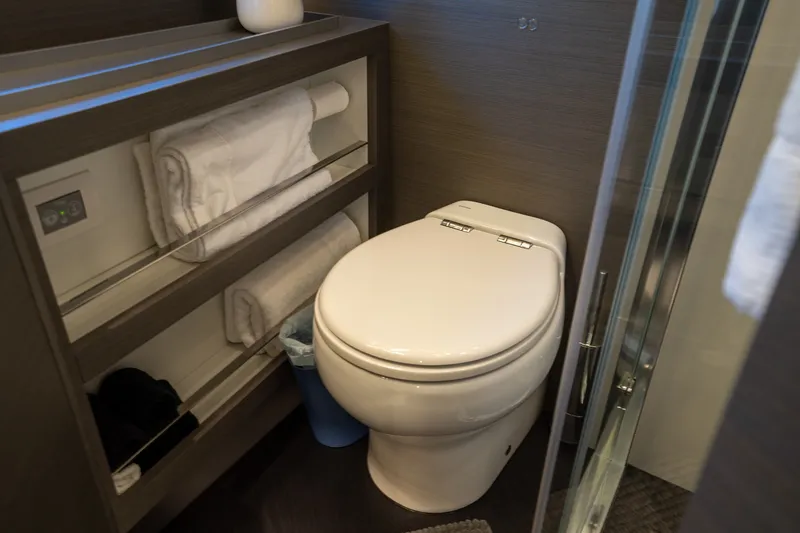 Slide: The Image of Luxury bathroom in 2023 Azimut S8 yacht with modern toilet and towel storage. - 19