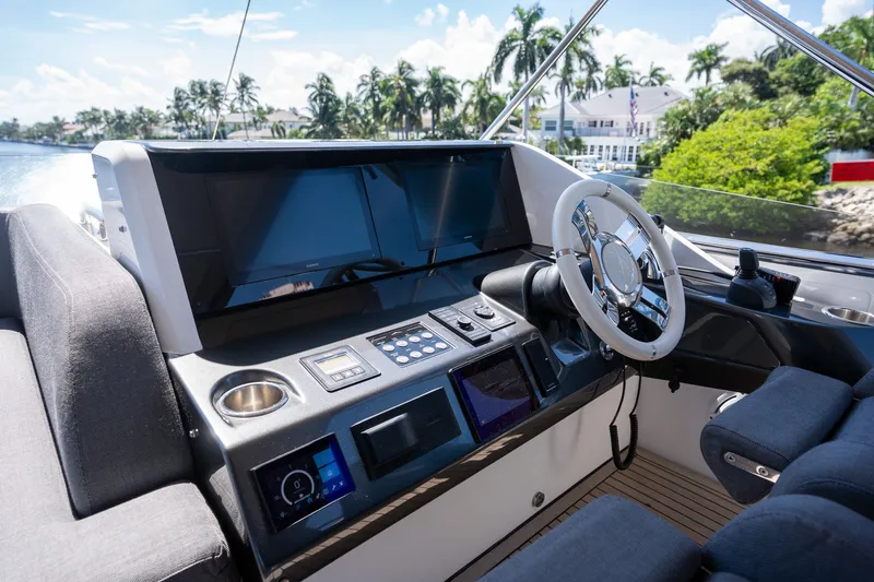 Slide: The Image of Cockpit of 2023 Azimut S8 yacht with modern controls and steering wheel. - 64