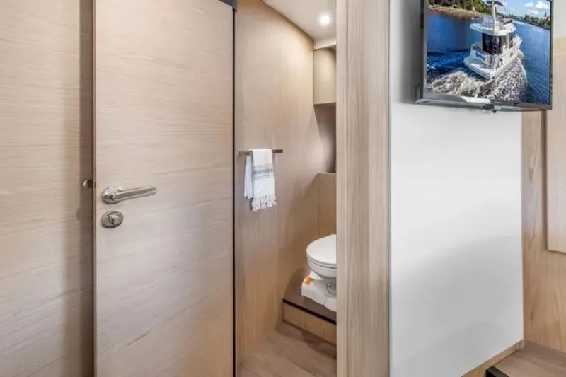 Slide: The Image of Interior of 2024 Beneteau Swift Trawler 41 Fly, featuring modern bathroom and wall-mounted TV. - 36