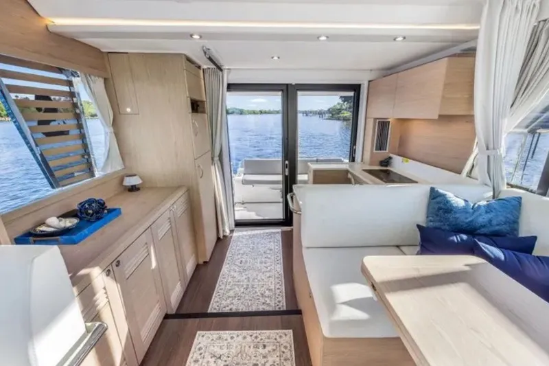 Slide: The Image of Luxurious interior of 2024 Beneteau Swift Trawler 41 Fly with modern furnishings and scenic water view. - 31