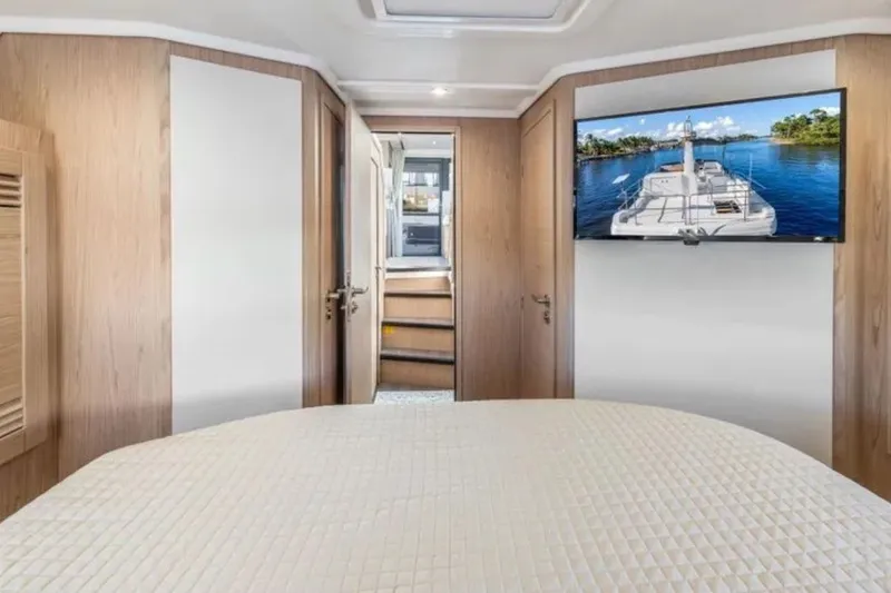 Slide: The Image of Interior of 2024 Beneteau Swift Trawler 41 Fly with cozy bedroom and TV. - 34