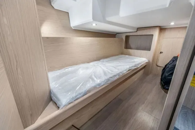 Slide: The Image of 2024 Beneteau Swift Trawler 41 Fly cabin interior with sleek wooden finish and cozy bed. - 35