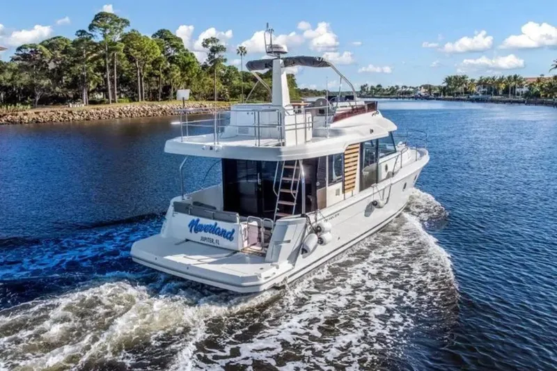 Slide: The Image of 2024 Beneteau Swift Trawler 41 Fly cruising on a scenic waterway. - 3