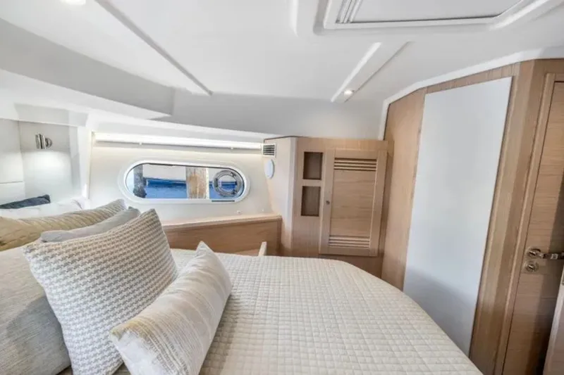 Slide: The Image of Luxurious cabin interior of 2024 Beneteau Swift Trawler 41 Fly, featuring elegant bedding and wood finishes. - 38