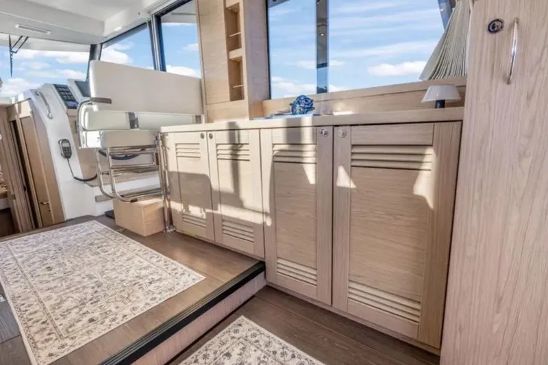 Slide: The Image of Interior of 2024 Beneteau Swift Trawler 41 Fly, featuring elegant wood cabinetry and modern design. - 27