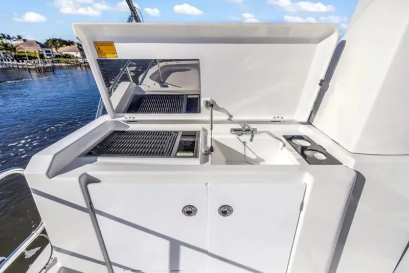 Slide: The Image of Outdoor kitchen on 2024 Beneteau Swift Trawler 41 Fly, featuring grill and sink. - 19