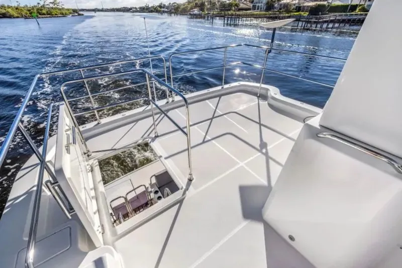 Slide: The Image of 2024 Beneteau Swift Trawler 41 Fly deck overlooking serene waterway. - 17