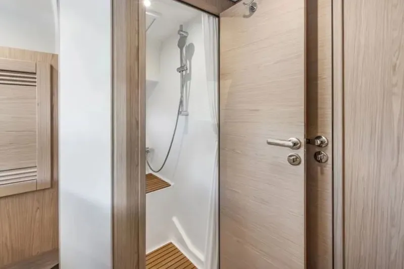 Slide: The Image of 2024 Beneteau Swift Trawler 41 Fly shower area with modern wood accents and sleek design. - 40