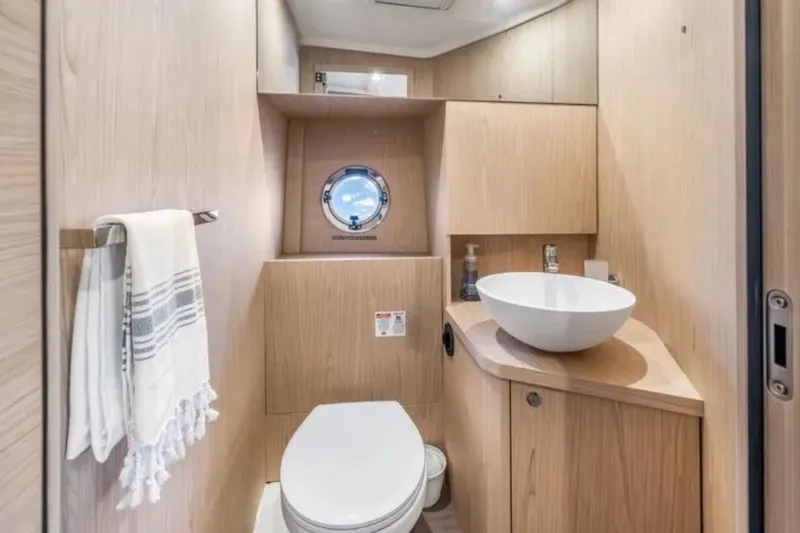Slide: The Image of Modern bathroom interior on 2024 Beneteau Swift Trawler 41 Fly, featuring sleek wood finishes. - 41