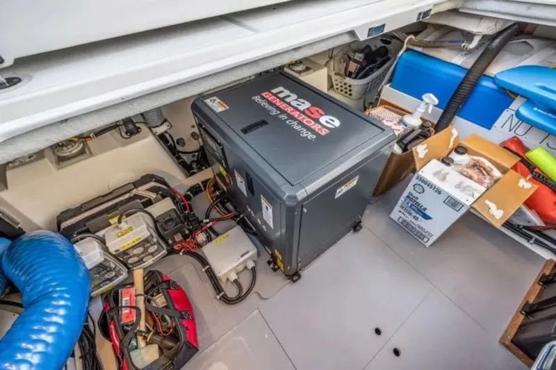 Slide: The Image of Engine room of 2024 Beneteau Swift Trawler 41 Fly with generator and equipment. - 48