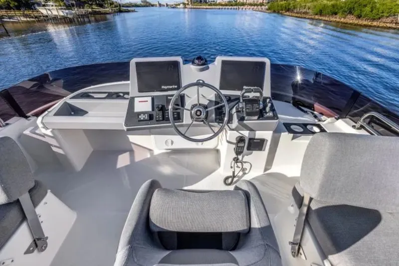 Slide: The Image of Flybridge helm of 2024 Beneteau Swift Trawler 41 Fly, featuring modern navigation equipment. - 23