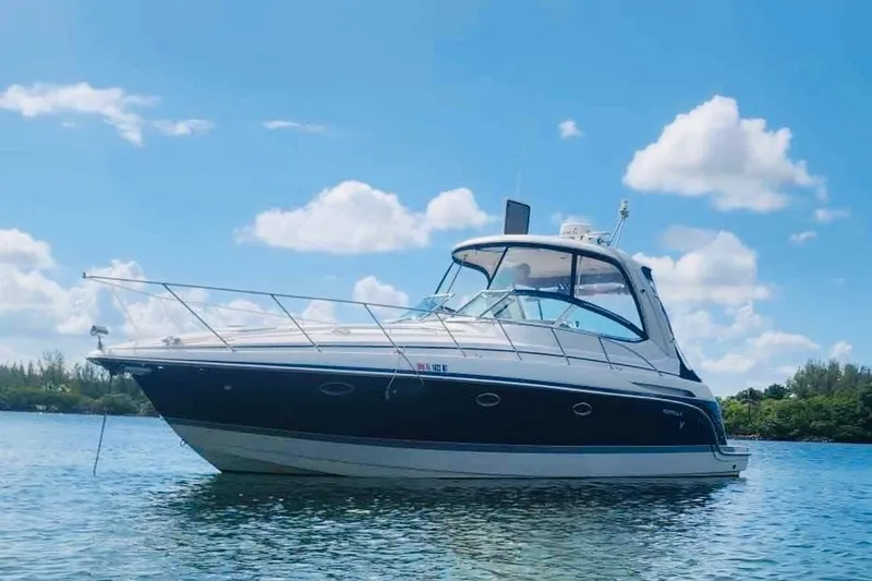 The Image of 2005 Formula 37 Performance Cruiser on calm water under blue sky. - 0