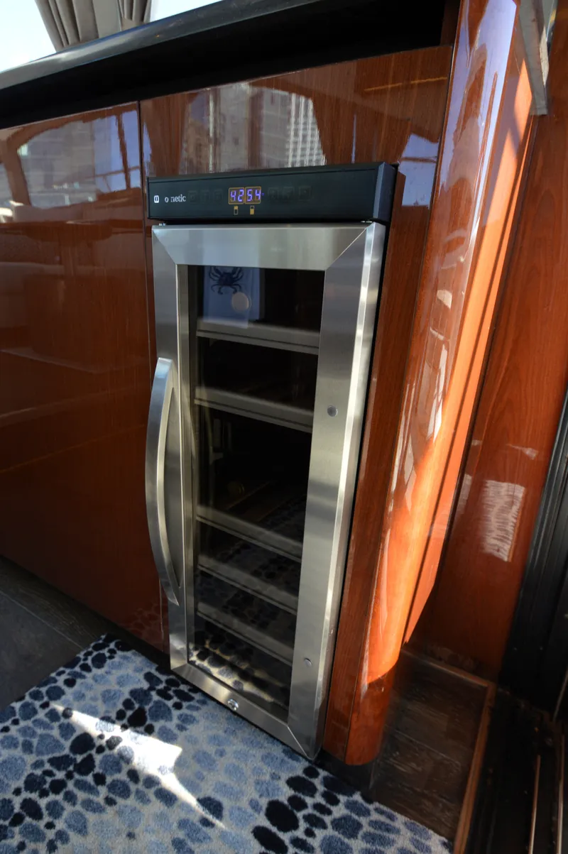 Slide: The Image of A sleek wine cooler in a luxurious yacht cabin with wooden walls and carpeted floor. - 30