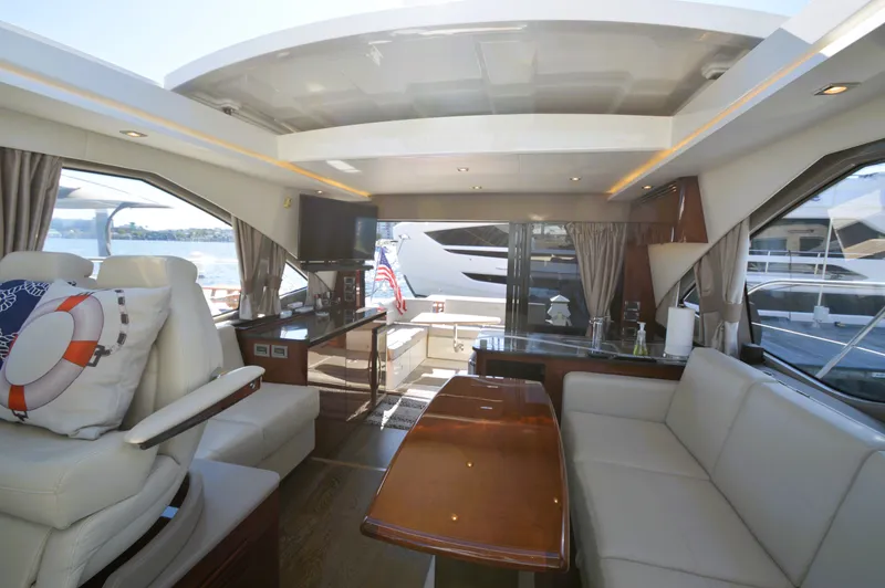 Slide: The Image of Interior of a 2018 Sea Ray 460 Express Cruiser with elegant furnishings and large windows. - 23