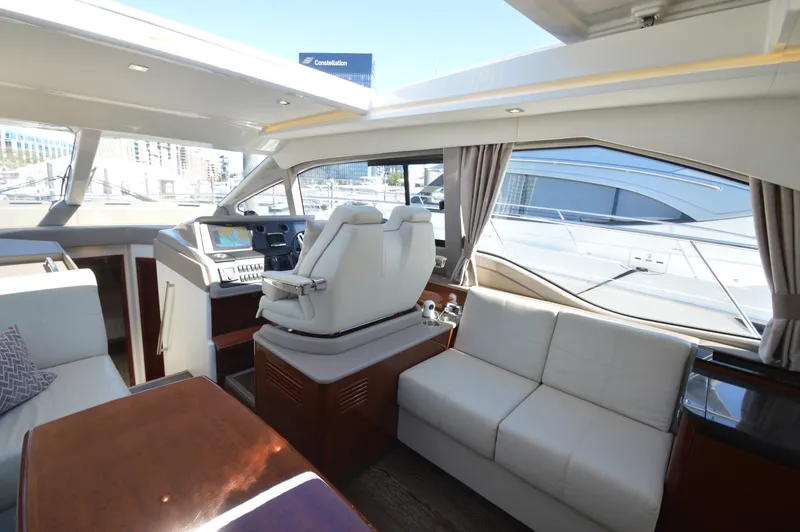 Slide: The Image of Interior of a 2018 Sea Ray 460 Express Cruiser with sleek seating and modern amenities. - 21