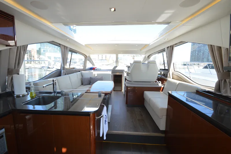 Slide: The Image of Interior of a luxury yacht with sleek kitchen, comfortable sofas, and large windows. - 18