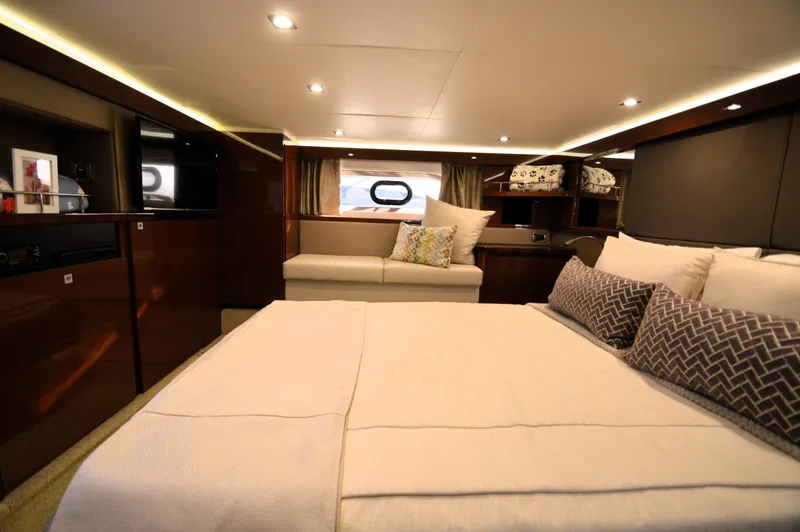 Slide: The Image of Luxurious bedroom with a large bed, pillows, and a sofa, surrounded by wood paneling. - 37