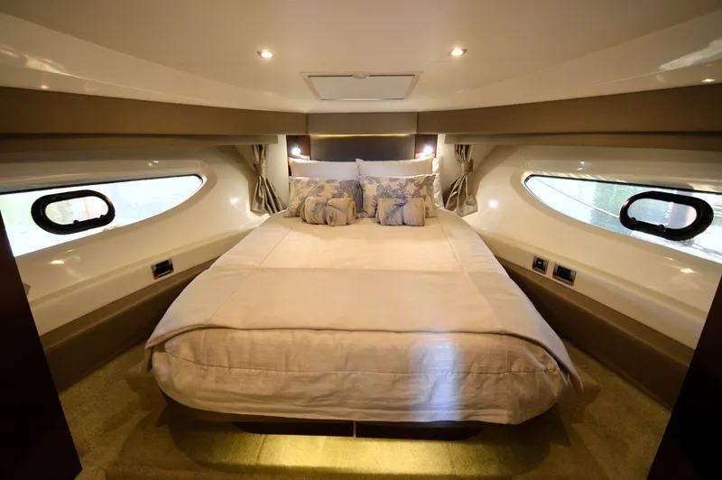 Slide: The Image of Luxurious bedroom with a large bed and elegant lighting in a Sea Ray 460 Express Cruiser. - 45