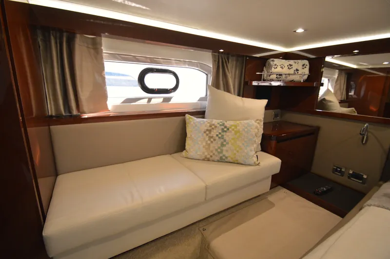 Slide: The Image of Interior of a 2018 Sea Ray 460 Express Cruiser with an elegant seating area and window. - 40