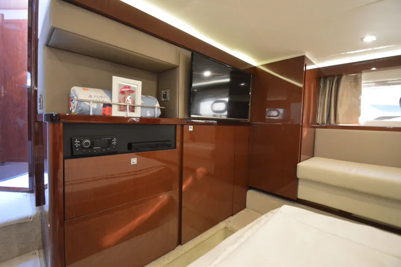 Slide: The Image of Interior of a 2018 Sea Ray 460 Express Cruiser with wood paneling and a flat-screen TV. - 39