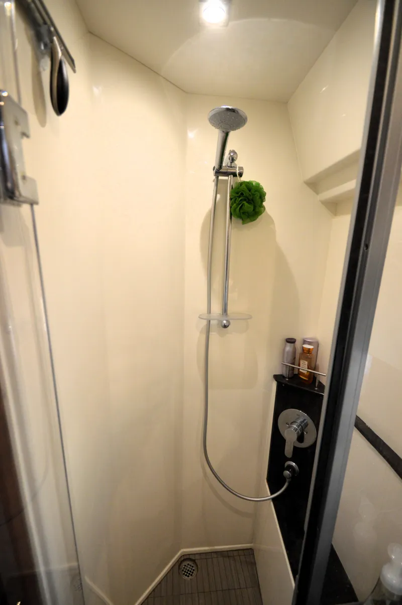 Slide: The Image of The shower in the 2018 Sea Ray 460 Express Cruiser is modern and compactly designed. - 43