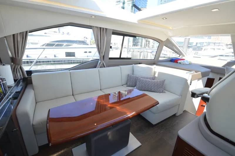 Slide: The Image of Interior of a Sea Ray 460 Express Cruiser with elegant white couch and wooden table. - 20