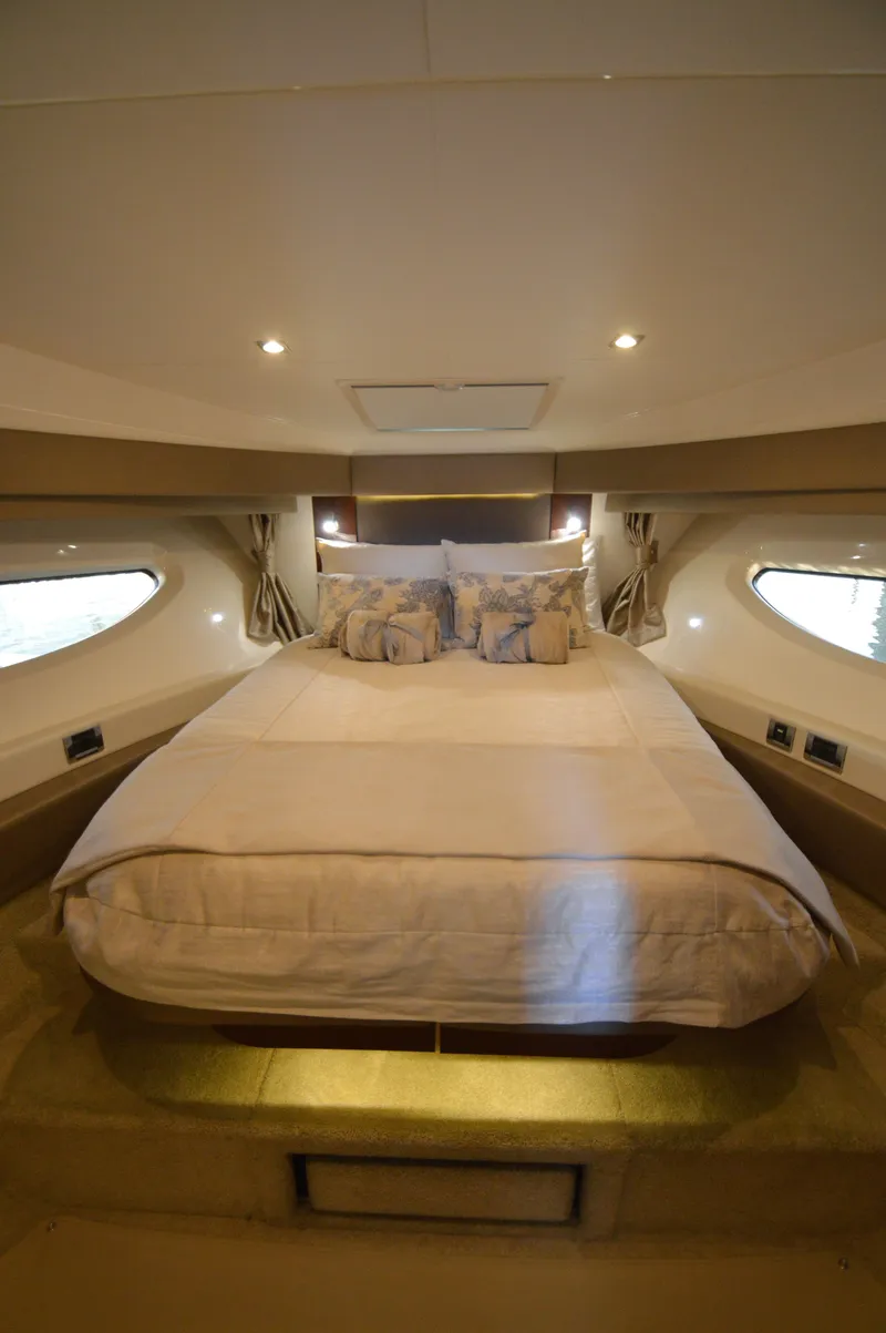 Slide: The Image of Cabin with a large bed, surrounded by windows and soft lighting. - 46