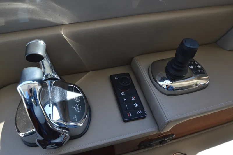 Slide: The Image of Control console of the Sea Ray 460 Express Cruiser with joystick and controls. - 35