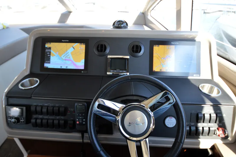 Slide: The Image of The image shows the helm of a Sea Ray 460 Express Cruiser with two navigation screens. - 34