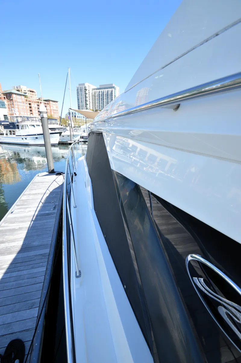 Slide: The Image of The 2018 Sea Ray 460 Express Cruiser is docked with city buildings in the background. - 14