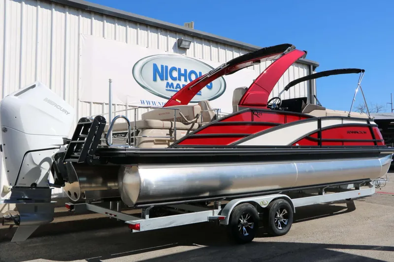 Slide: The Image of 2027 Bennington 25 QSBA Tri Toon with red and black design, on a trailer. - 22