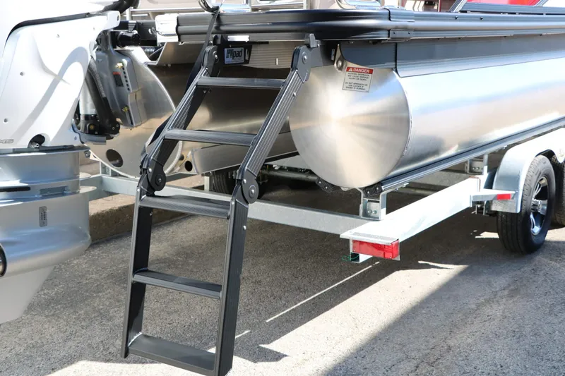 Slide: The Image of The 2027 Bennington 25 QSBA Tri Toon features a sturdy ladder and robust hull. - 32