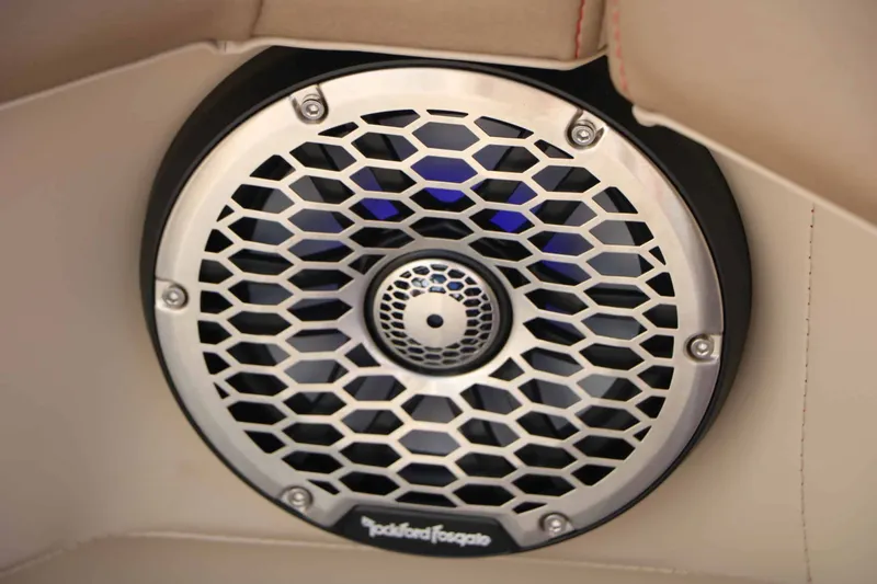 Slide: The Image of Close-up of a speaker with a hexagonal grille in a 2027 Bennington 25 QSBA Tri Toon. - 42