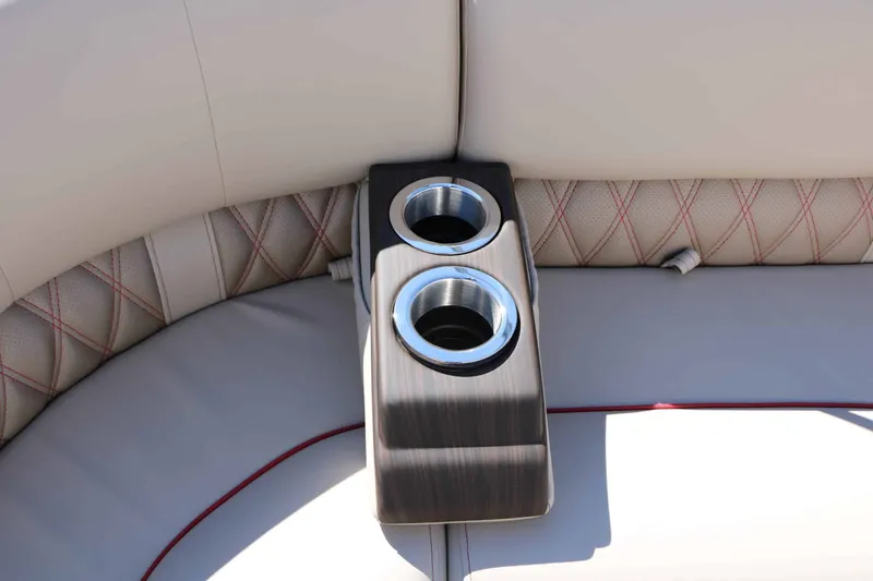 Slide: The Image of The Bennington 25 QSBA Tri Toon features a sleek, upholstered bench seat with built-in cup holders. - 38