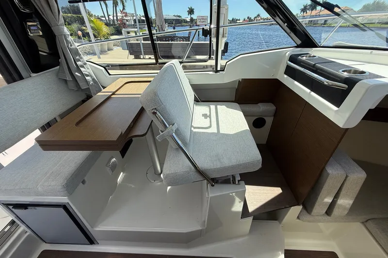 Slide: The Image of Interior of 2022 Jeanneau NC 795 Series 2 boat with seating and table by the window. - 11