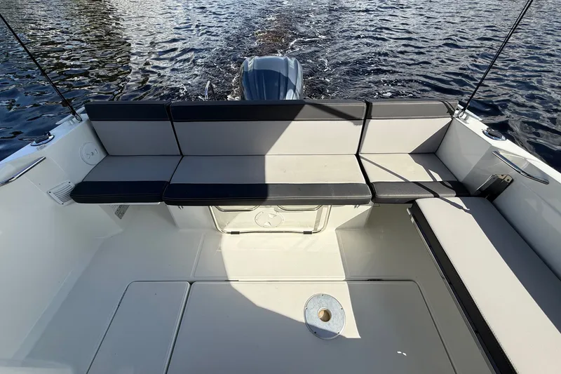 Slide: The Image of 2022 Jeanneau NC 795 Series 2 boat interior with cushioned seating and water view. - 22